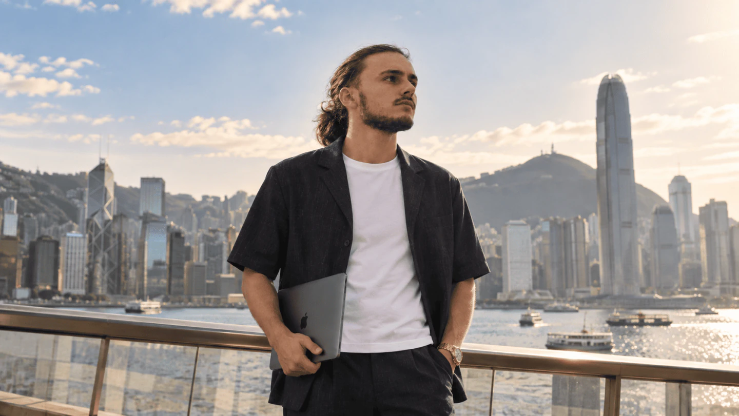 Axel overlooking Hong Kong's waterfront skyline in daylight